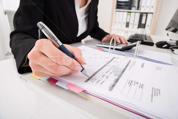 Businesswoman Hand Calculating Business Report Stock photo © AndreyPopov