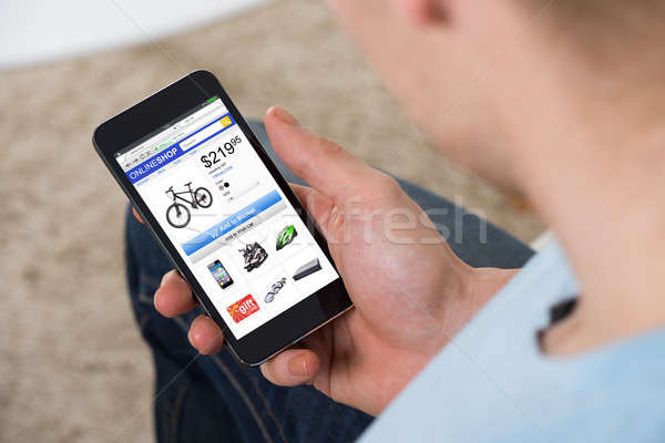 Man Doing Online Shopping On Mobilephone Stock photo © AndreyPopov
