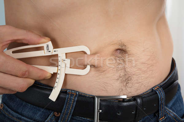 Pessoa gordura medir corpo homem Foto stock © AndreyPopov