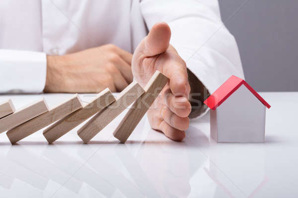 Human Hand Stopping The Wooden Blocks From Falling Stock photo © AndreyPopov