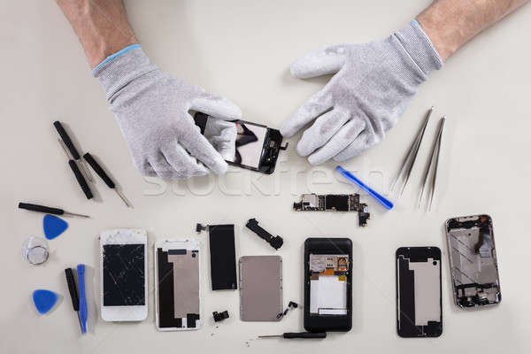 Stock photo: Person Repairing Mobile Phone