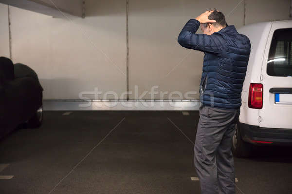 Stock photo: Rear View Of A Shocked Man Standing In Parking Lot
