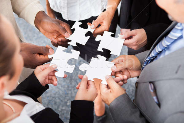 Businesspeople Holding Jigsaw Puzzle Stock photo © AndreyPopov