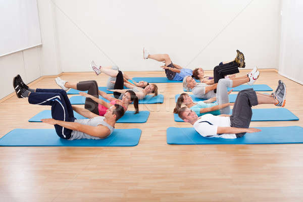 Group of people exercsning in a gym class Stock photo © AndreyPopov