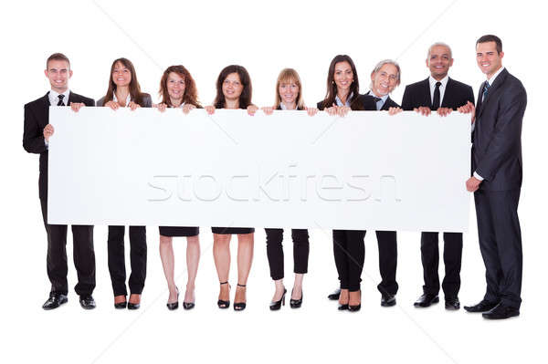 Group of business people with a blank banner Stock photo © AndreyPopov