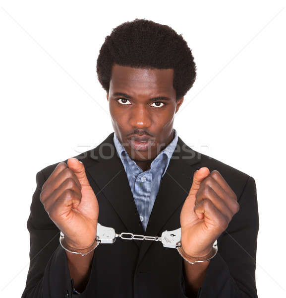 Verhaftet Mann Handschellen Hände jungen african Stock foto © AndreyPopov