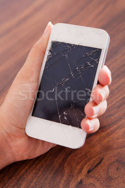 Hand Holding Smartphone With Cracked Screen Stock photo © AndreyPopov