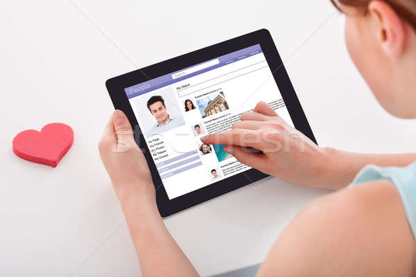 Stock photo: Woman Chatting On Social Networking Sites Using Digital Tablet
