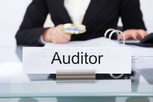 Stock photo: Auditor Scrutinizing Financial Documents