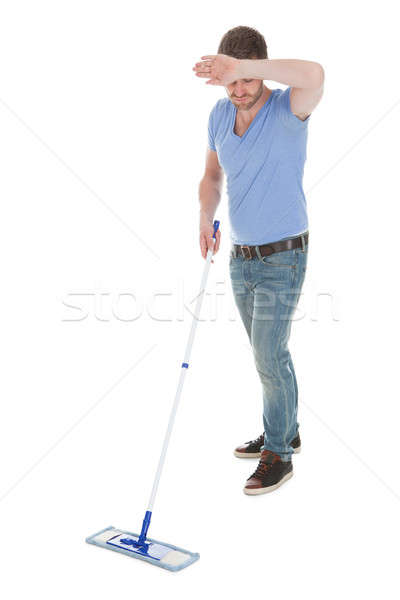 Tired Man Mopping Floor Over White Background Stock photo © AndreyPopov