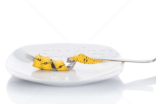 Stock photo: Fork Wrapped With Measure Tape In Plate