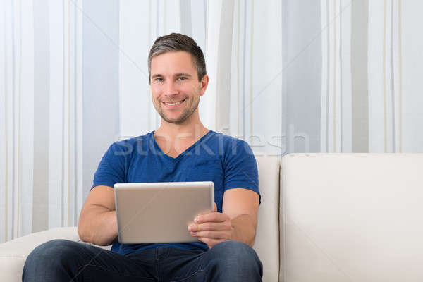 Portrait Of A Smiling Man Holding Digital Tablet Stock photo © AndreyPopov