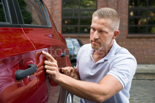 Man Looking For Scratches On His Car Stock photo © AndreyPopov