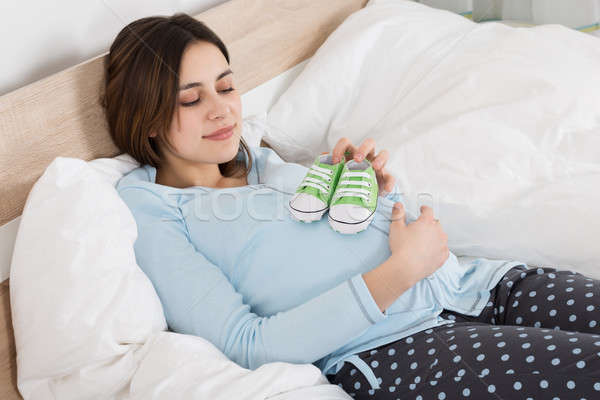Pregnant Woman Holding Small Shoes Stock photo © AndreyPopov