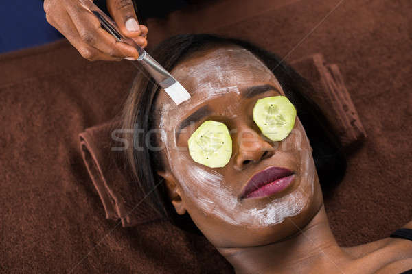 Woman Applying Facial Mask In Spa Stock photo © AndreyPopov