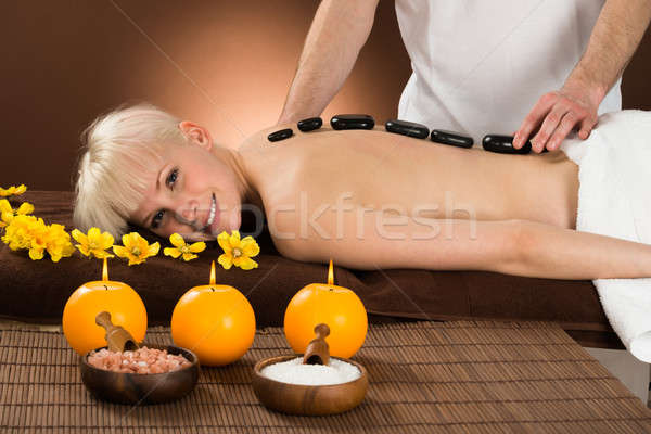 Young Woman Receiving Hot Stone Therapy Stock photo © AndreyPopov