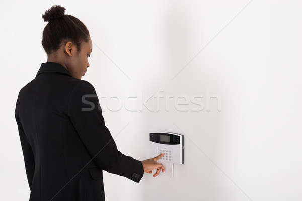 Businesswoman Entering Code In Security System Stock photo © AndreyPopov