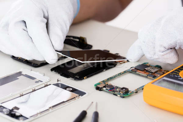 Person Fixing Damaged Screen On Mobile Phone Stock photo © AndreyPopov