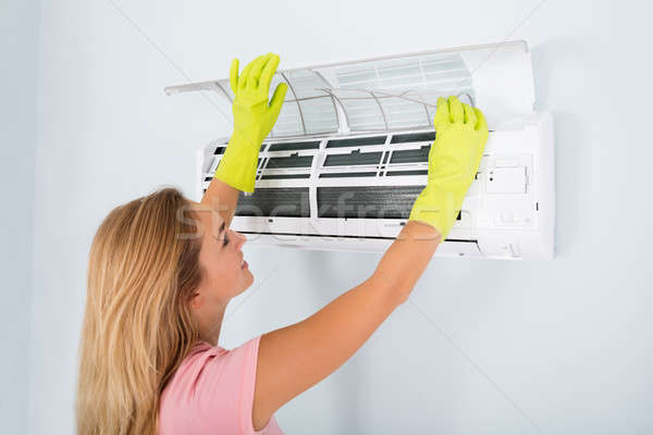Woman Checking Air Conditioner Stock photo © AndreyPopov