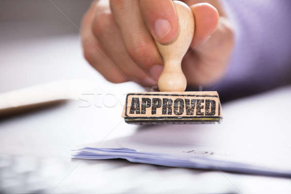 Person's Hand Holding Approved Stamp On Document Stock photo © AndreyPopov