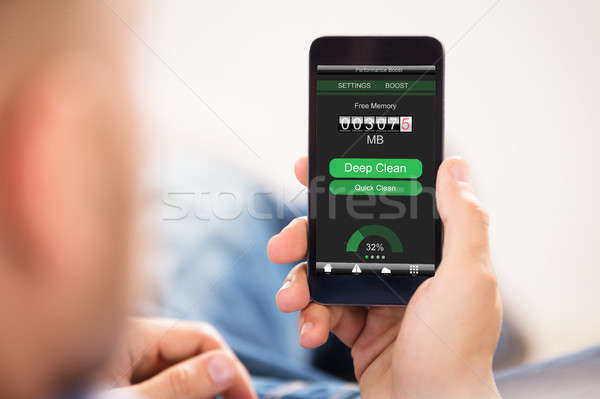 Man Optimizing Smart Phone  Stock photo © AndreyPopov