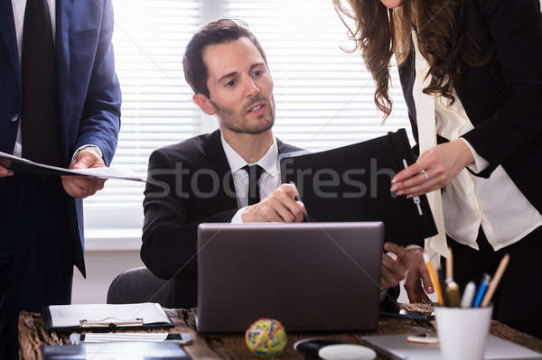 Young Businessman Looking At Document Stock photo © AndreyPopov