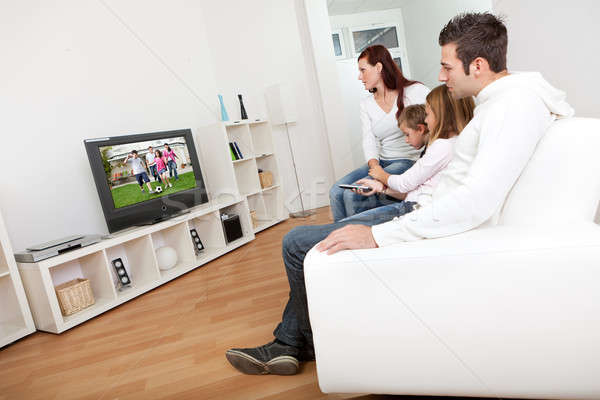 Young family watching TV at home Stock photo © AndreyPopov