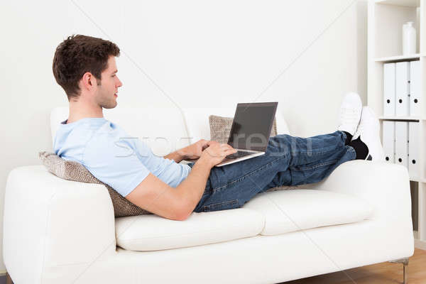 Young Man Using Laptop Stock photo © AndreyPopov