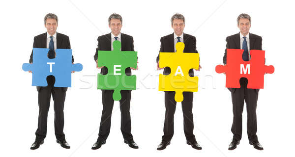 Group of business people holding jigsaw puzzle Stock photo © AndreyPopov