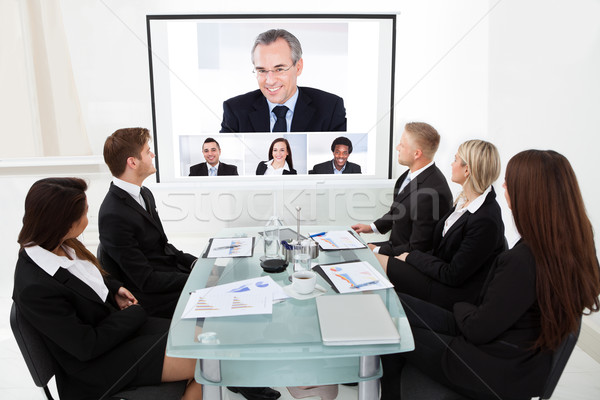 Stock photo: Businesspeople Looking At Projector Screen