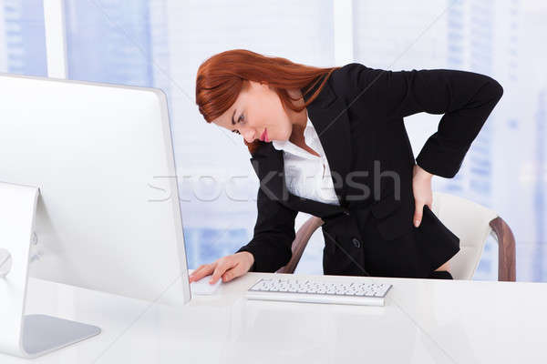 Femme d'affaires souffrance mal de dos ordinateur bureau fatigué Photo stock © AndreyPopov