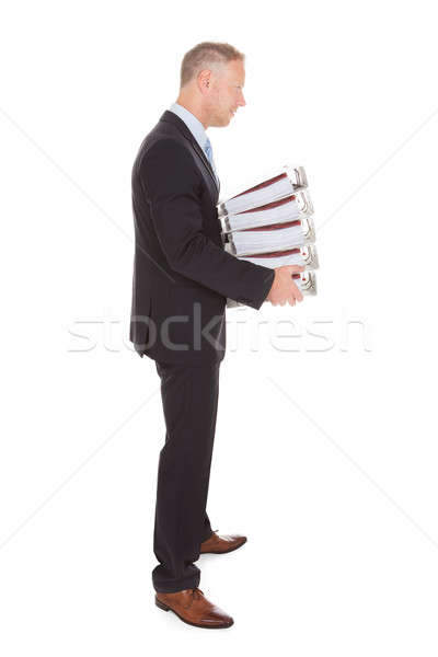 Sad Businessman Carrying Stack Of Binders Stock photo © AndreyPopov