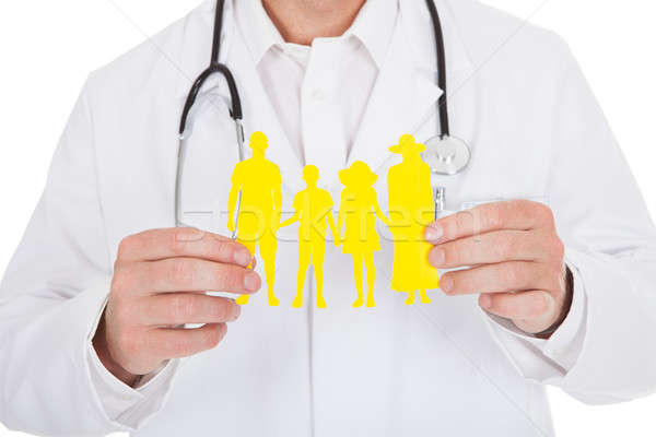 Médecin de sexe masculin papier chaîne famille blanche Photo stock © AndreyPopov