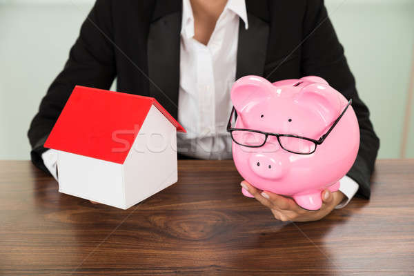 Stock photo: Businesswoman With House And Piggybank