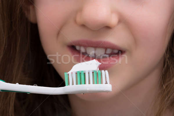 Stock photo: Close-up Of Girl Brushing Teeth