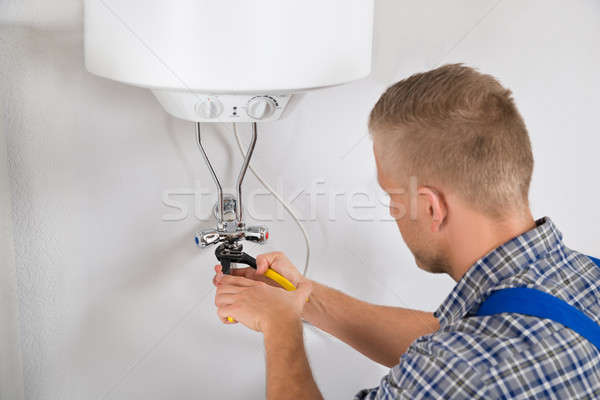 Repairman Repairing Electric Boiler Stock photo © AndreyPopov