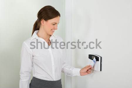 Businesswoman Inserting Keycard In Security System Stock photo © AndreyPopov
