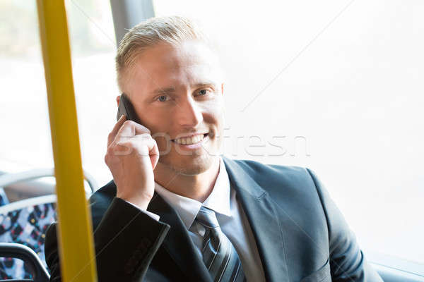 Zakenman praten mobieltje glimlachend tram Stockfoto © AndreyPopov