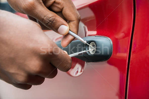 Person Hand Opening Car Door With Lockpicker Stock photo © AndreyPopov