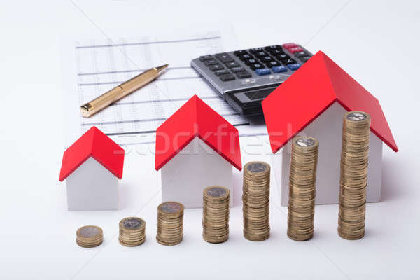Stack Of Coins In Front Of House Model And Documents Stock photo © AndreyPopov