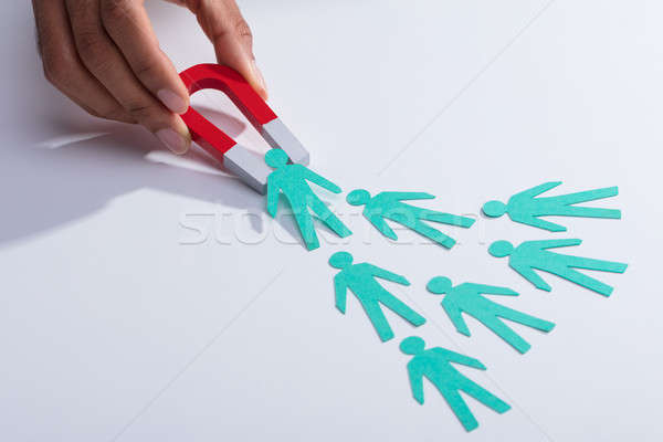 Businessperson Holding Magnet Attracting Paper Candidates Stock photo © AndreyPopov
