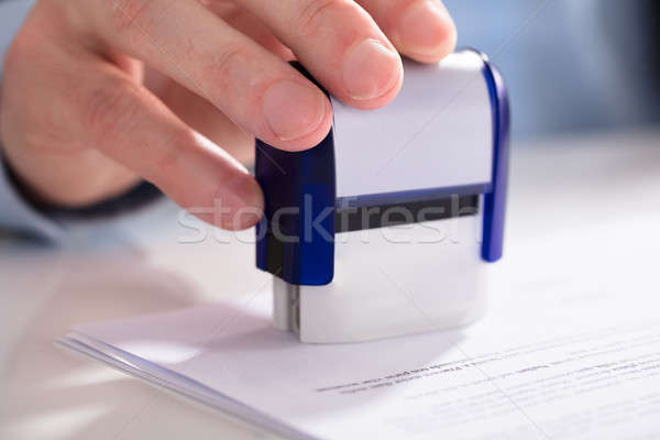 Businessperson Using Stamper On Document Stock photo © AndreyPopov