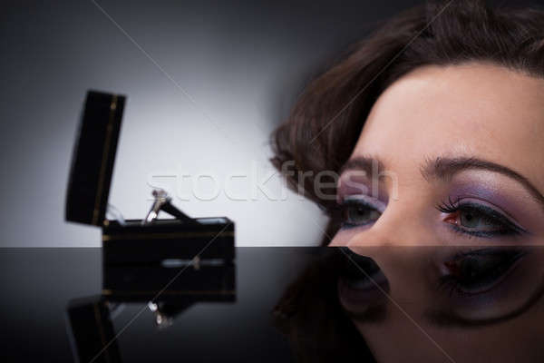 Young Woman Looking At Wedding Ring Stock photo © AndreyPopov