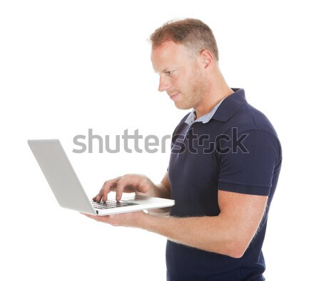 Man Using Laptop Over White Background Stock photo © AndreyPopov