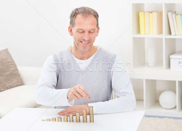 Mature Man Stacking Coins Stock photo © AndreyPopov