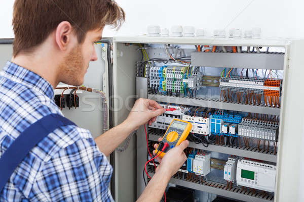 Technician Examining Fusebox With Insulation Resistance Tester Stock photo © AndreyPopov