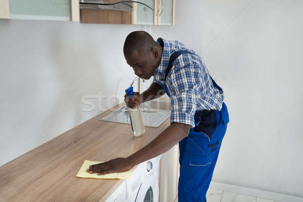 Man Cleaning Kitchen Worktop Stock photo © AndreyPopov