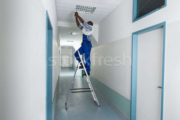 Electrician Installing Light On Ceiling Stock photo © AndreyPopov