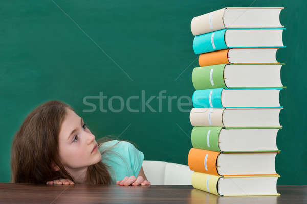 Afraid Girl Looking At Colorful Books Stock photo © AndreyPopov
