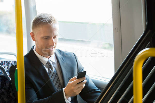 Geschäftsmann Mobiltelefon jungen glücklich Sitzung Straßenbahn Stock foto © AndreyPopov